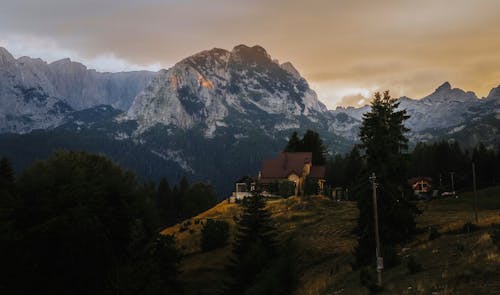 Buildings on Hill with Mountains behind