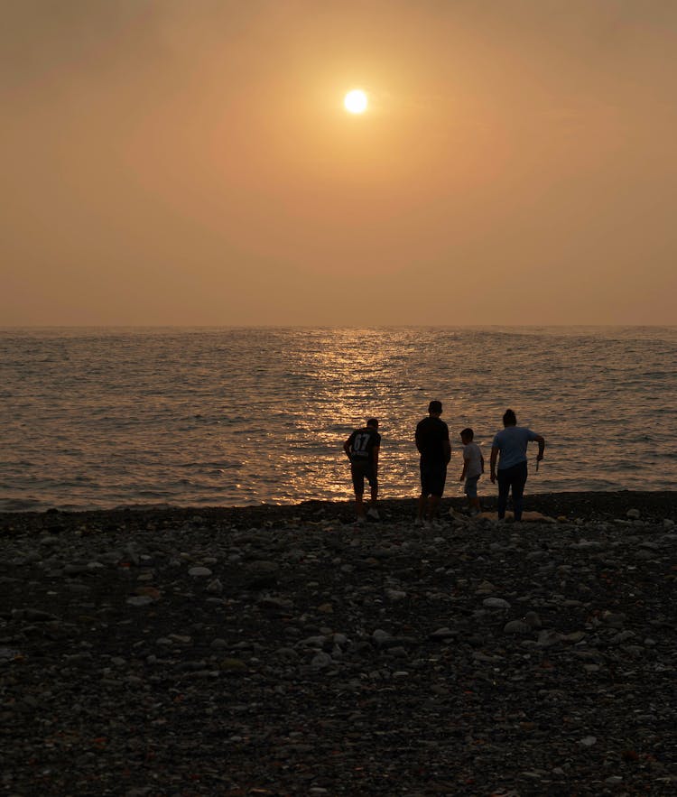 Family On Beach At Sunset