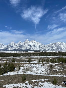 A stunning view of the snowy Grand Teton Mountains in winter, captured from Jackson, Wyoming.