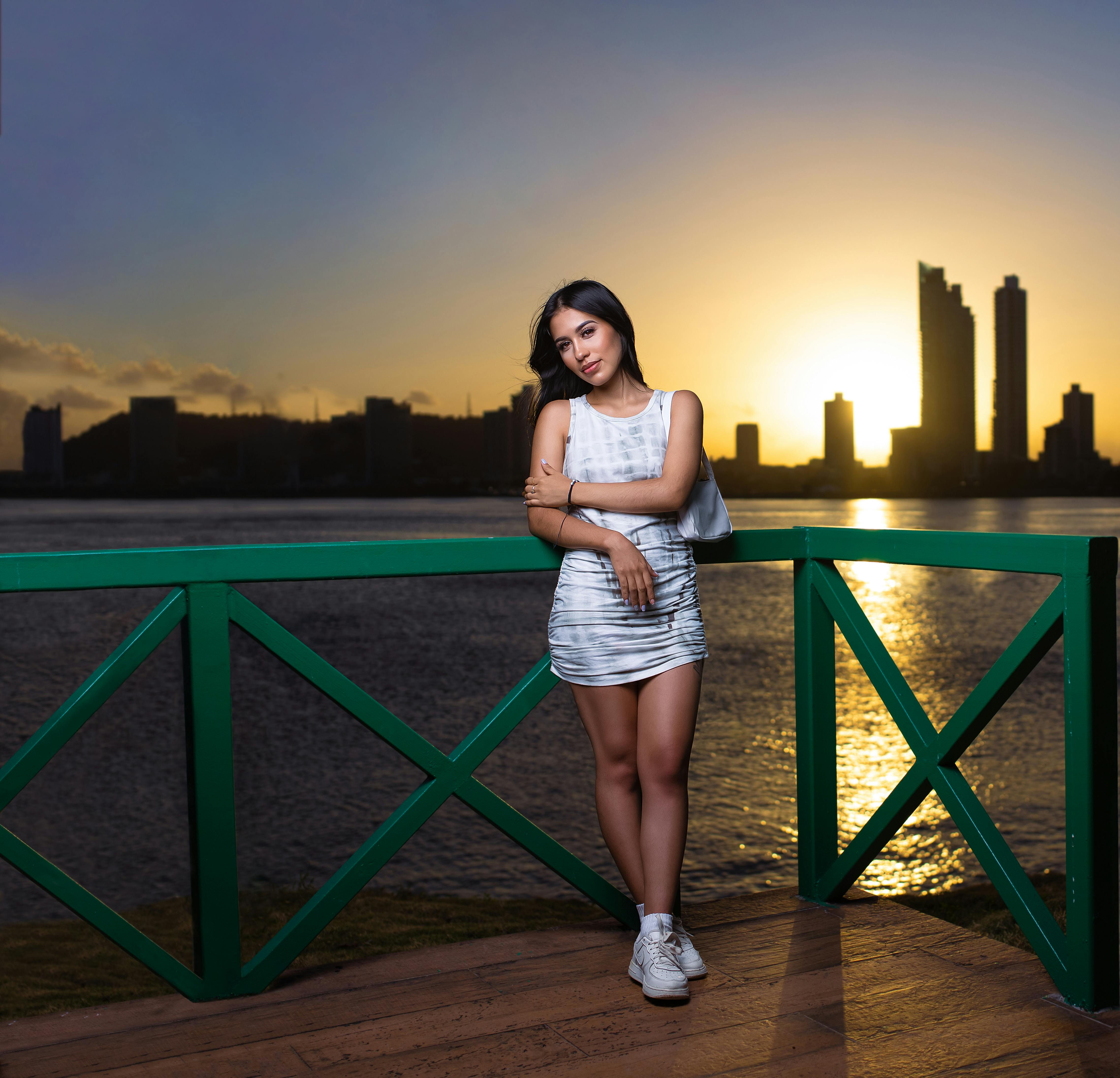 Brunette Woman Posing with Skyscrapers behind · Free Stock Photo