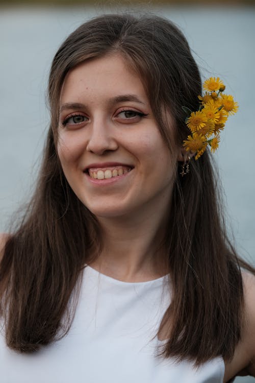 Portrait of Smiling Young Woman with Flowers in Hair