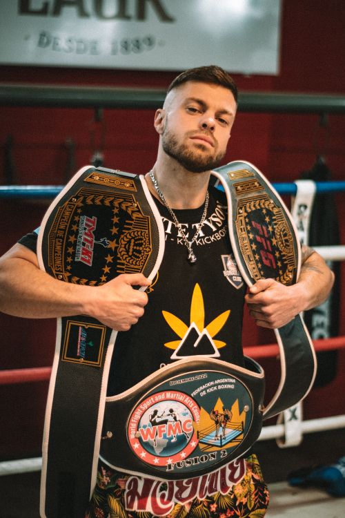 Boxer Standing in Ring with Belts · Free Stock Photo