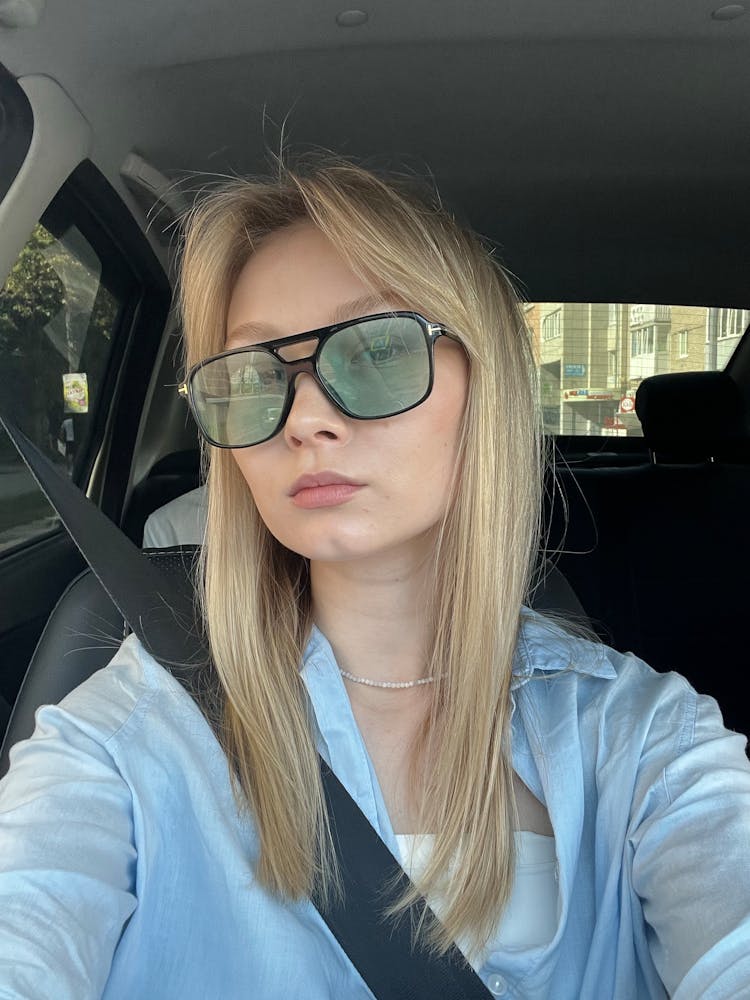 Young Woman Taking A Selfie In A Car 