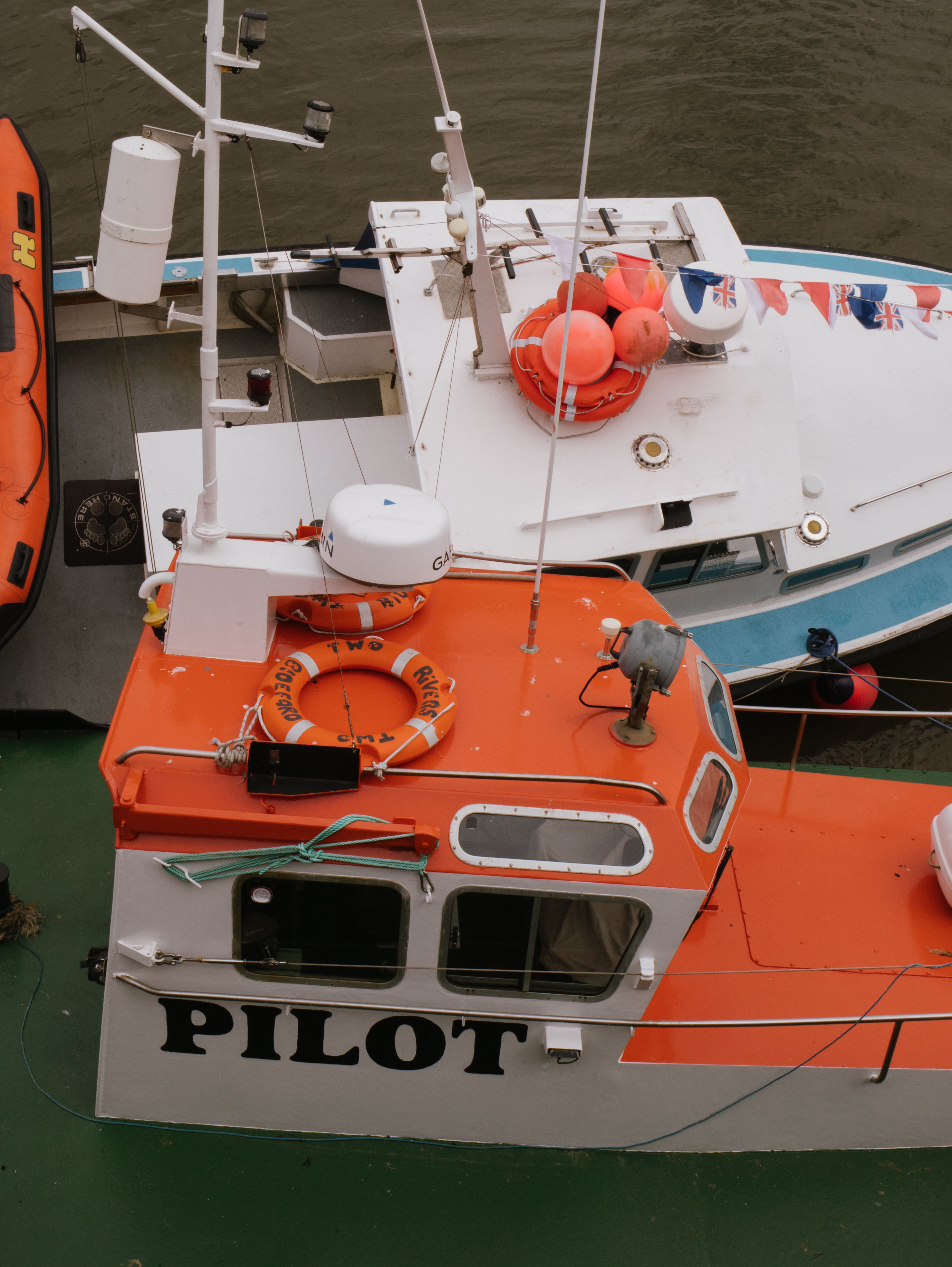 Top view of vibrant pilot boats moored in a bustling harbor, ready for the next marine adventure.