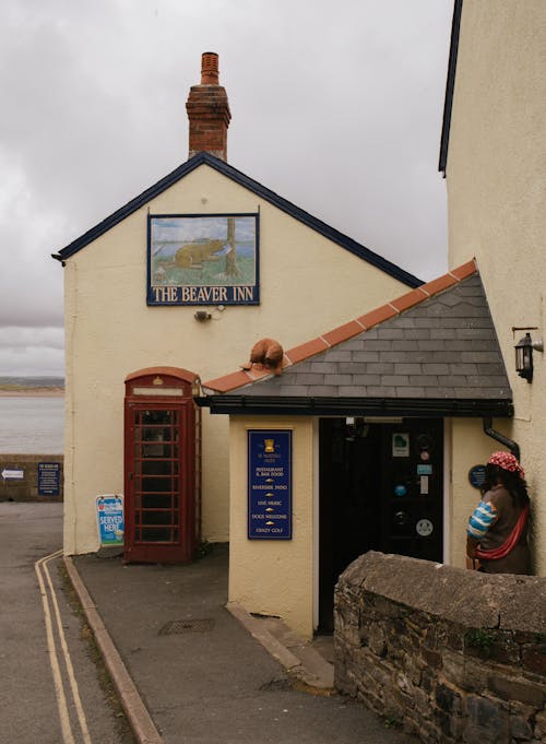 Woman Standing at The Beaver Inn in Appledor Village, Devon, UK