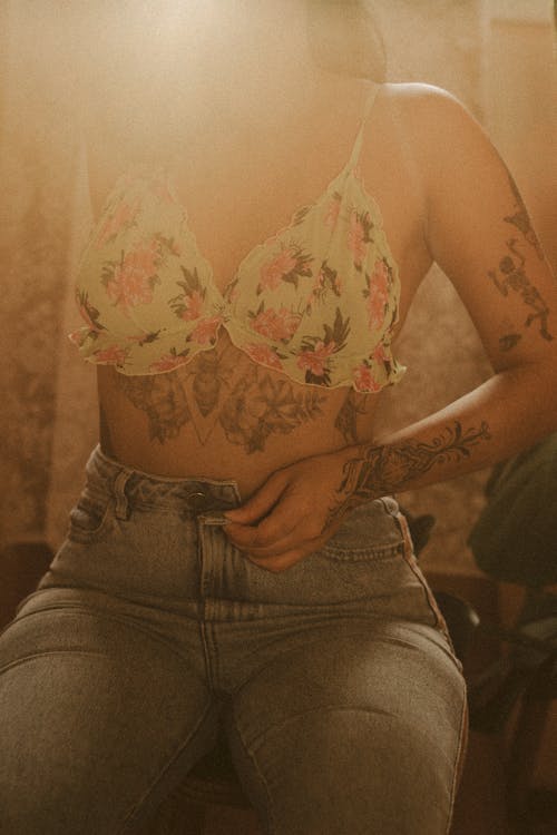 Woman in Floral Bralette Ubottoning Jeans