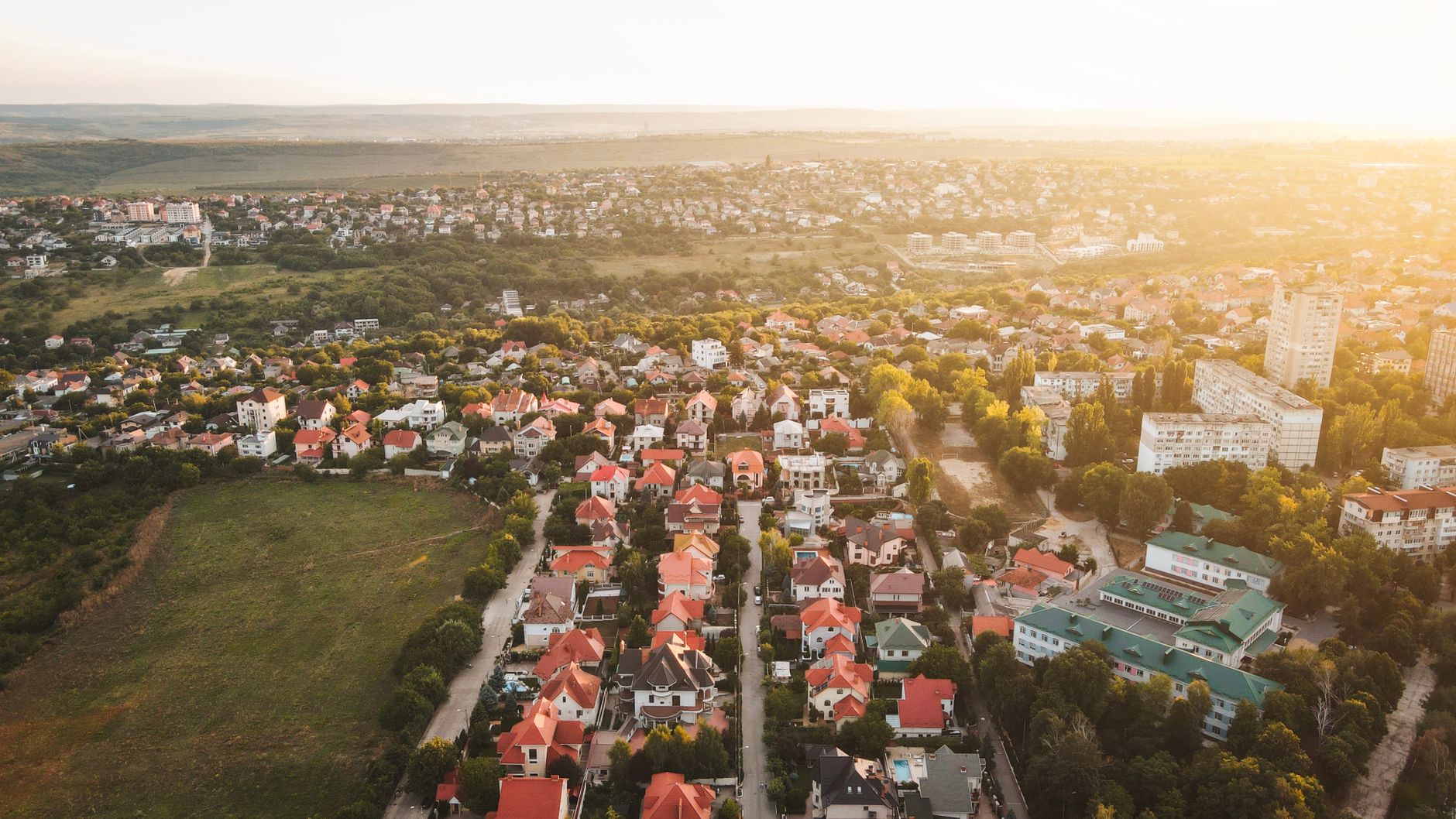 Aerial photograph of Chişinău, Moldova showcasing cityscape at sunset.