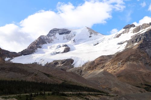 Free Majestic snow-capped mountains under a clear sky in Jasper National Park, Canada. Stock Photo