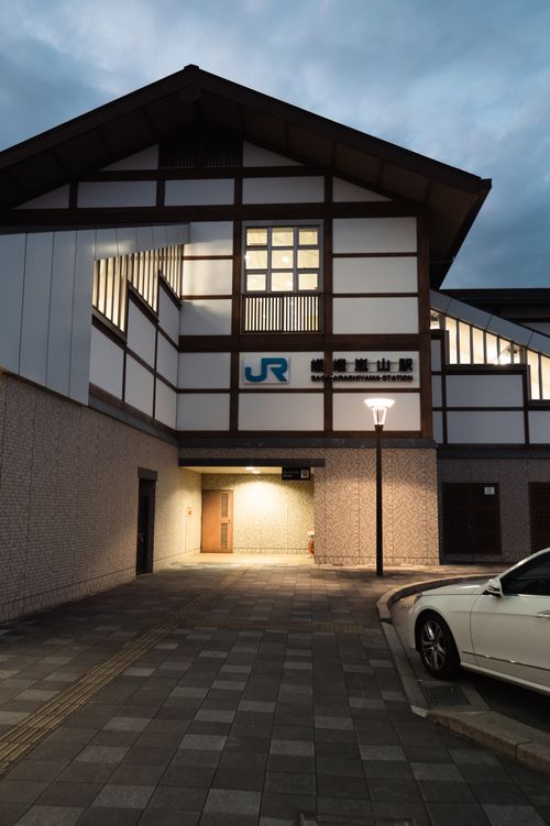 Free Kyōto's traditional architecture meets modern transit at dusk. Stock Photo