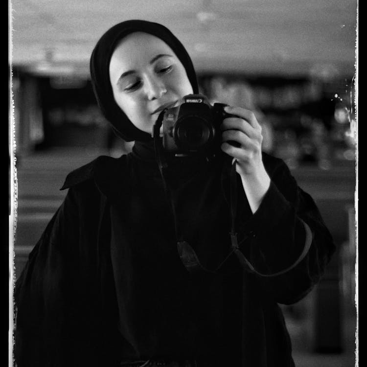 Woman Holding Digital Camera In Hand