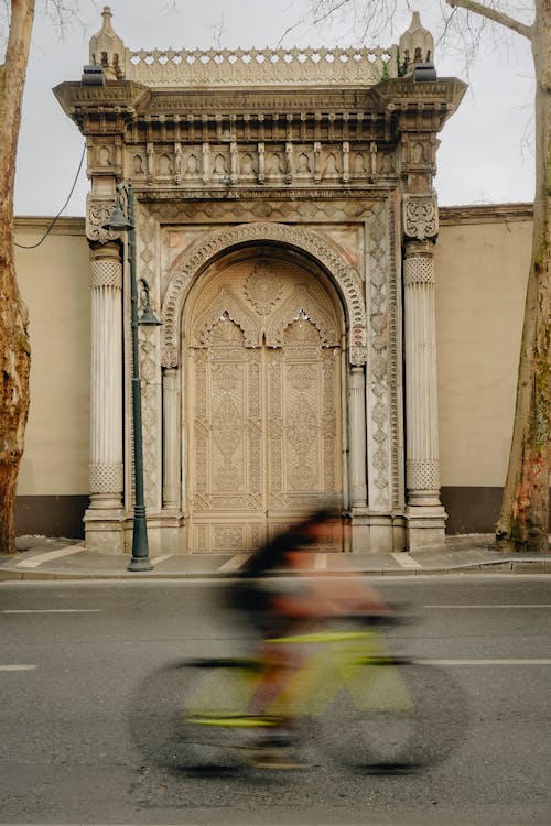 Cyclist Passing the Gate of the Ciragan Palace