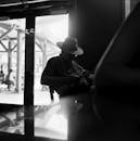 Man Sitting in Sunhat at Bar Counter