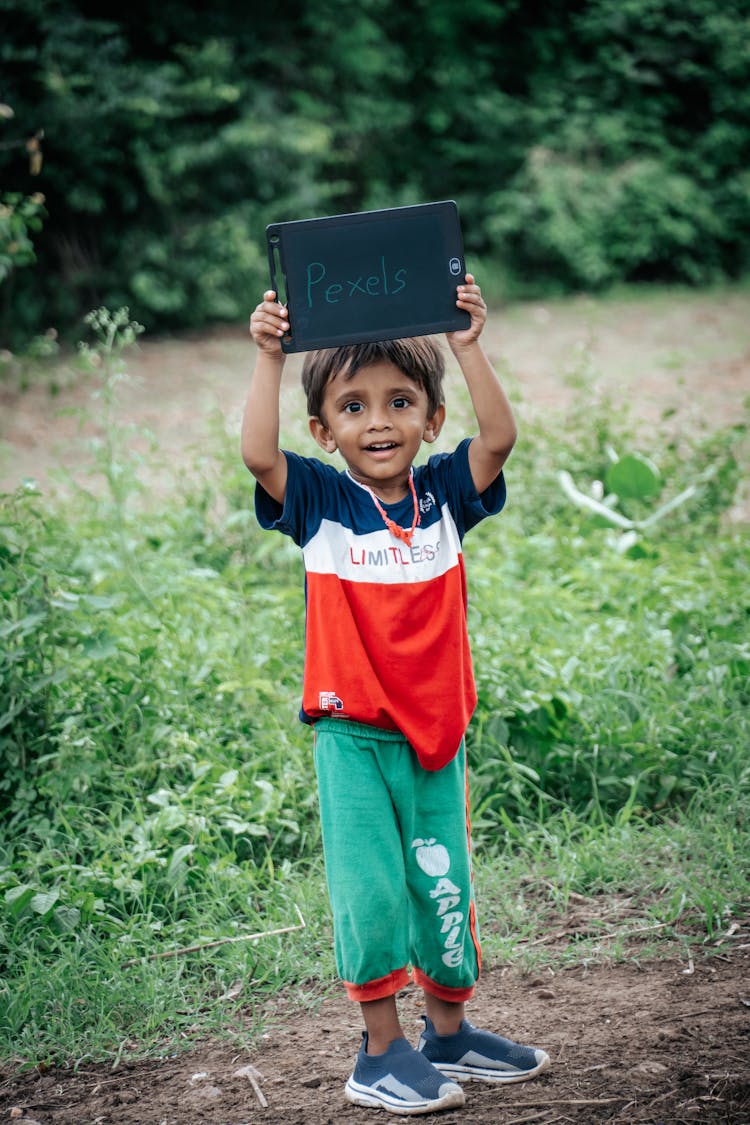 Smiling Boy Holding Board With Text