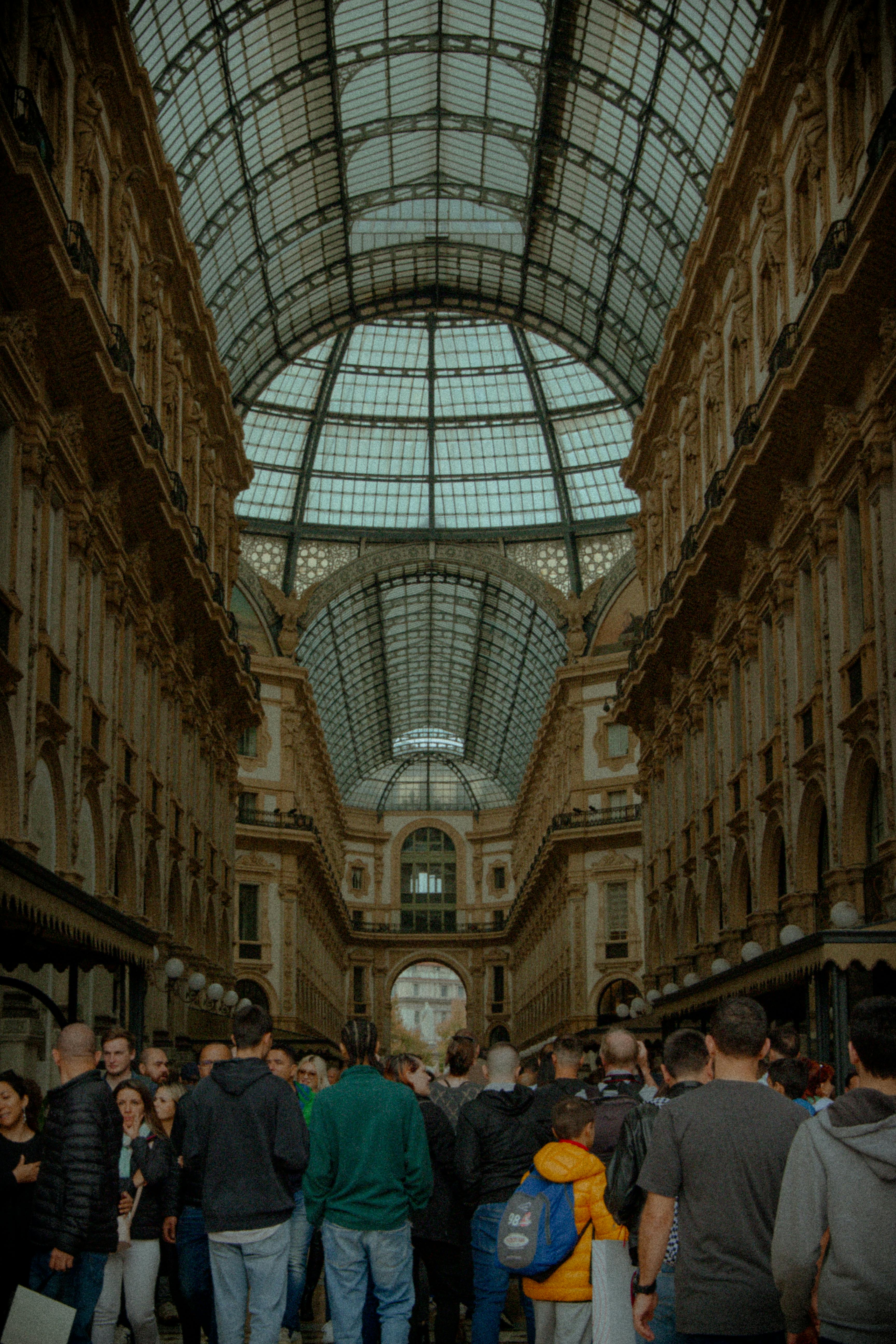 Crowd inside the historic Galleria Vittorio Emanuele II shopping mall in Milan, Italy.