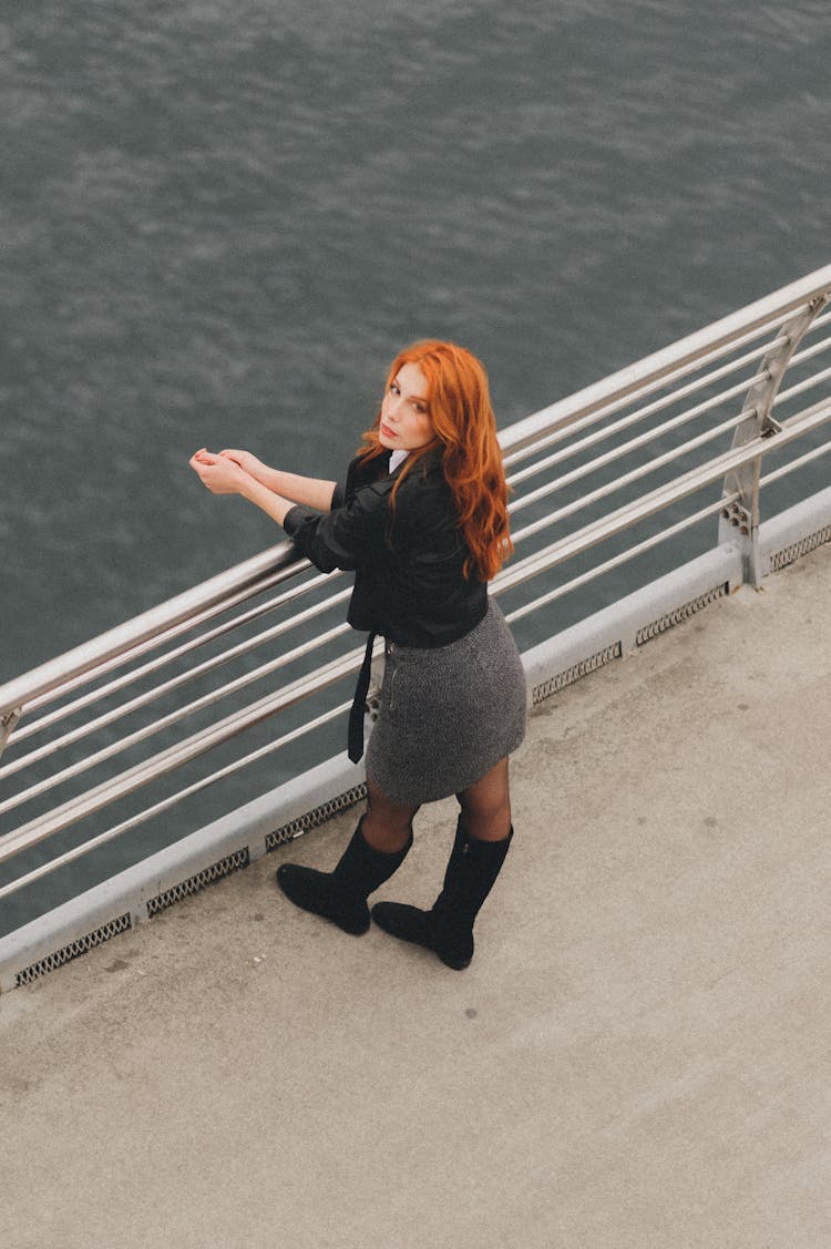 Redhead Woman Standing On Bridge