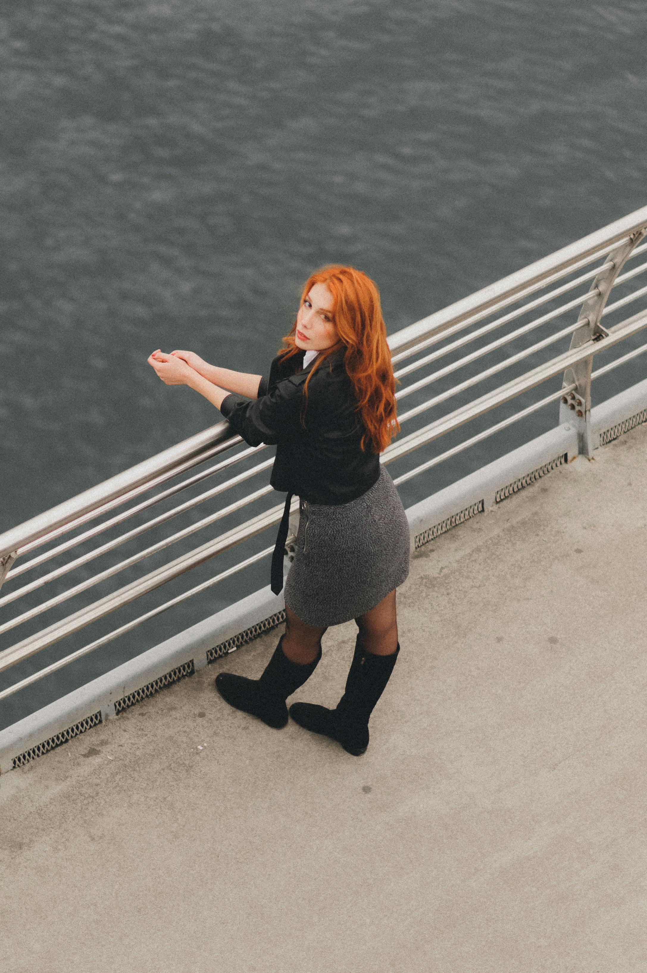 Redhead Woman Standing on Bridge · Free Stock Photo