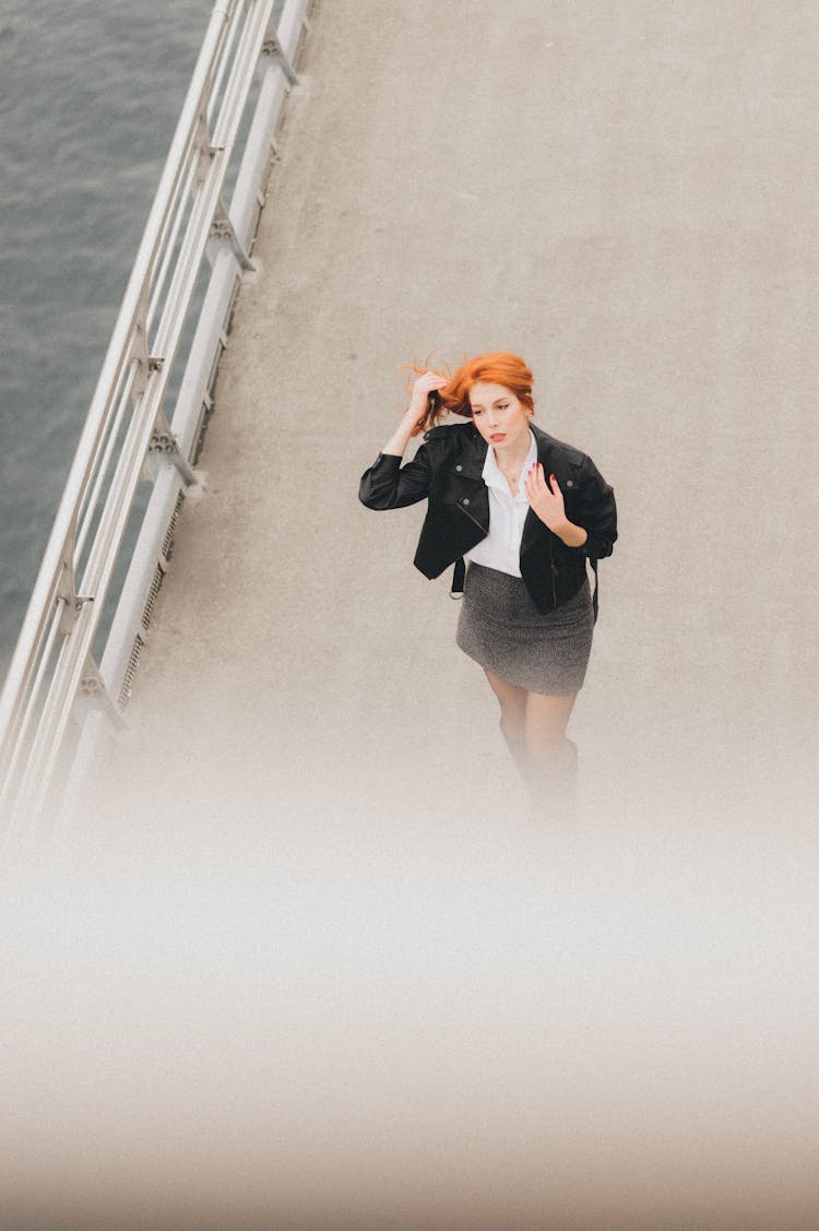 Redhead Woman Walking On Bridge
