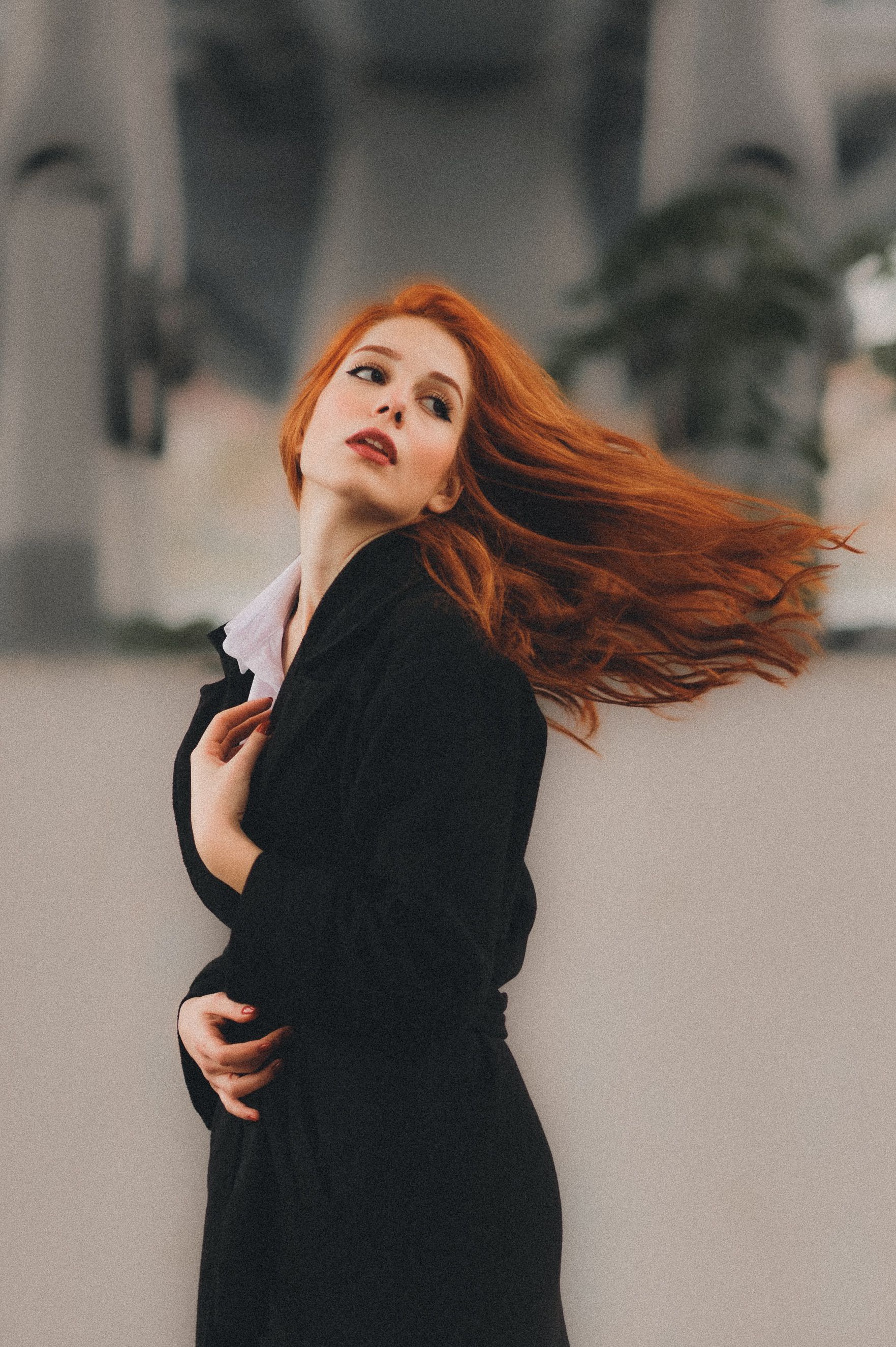 Redhead woman with hair flying in the wind