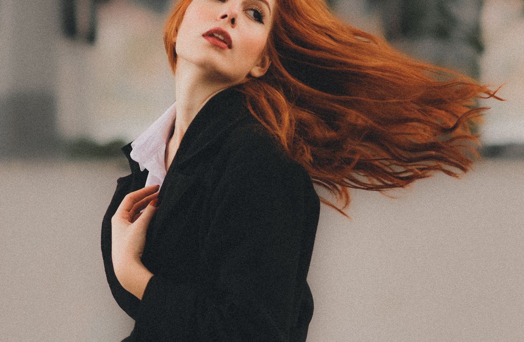 Redhead woman with hair flying in the wind