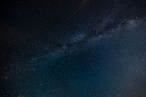 Free A stunning view of the starry night sky displaying the Milky Way galaxy. Stock Photo
