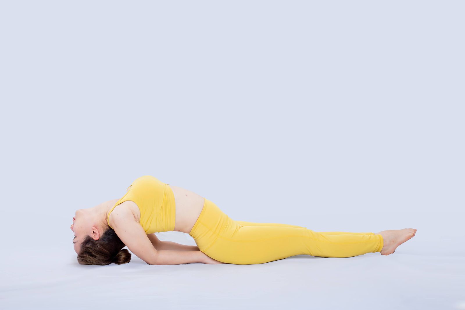 Woman practicing bridge pose yoga stretch to relieve lower back pain