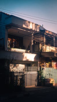 Aesthetic view of an urban home exterior with warm sunlight casting artistic shadows.