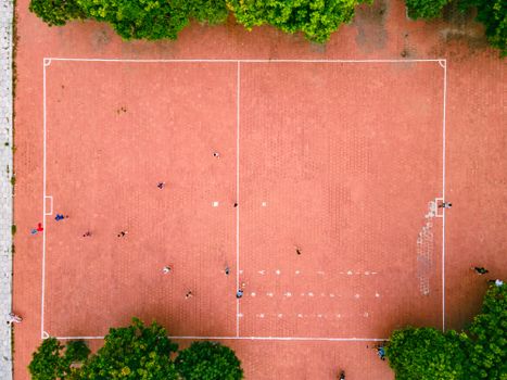 Aerial shot of a sports field in Hanoi, showing people playing and greenery around.
