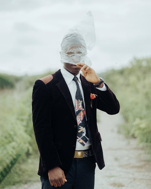 Elegant Man Wearing a Plastic Bag on His Head 