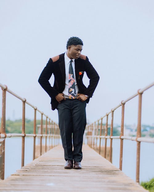 Young Elegant Man in a Suit Standing on a Pier 