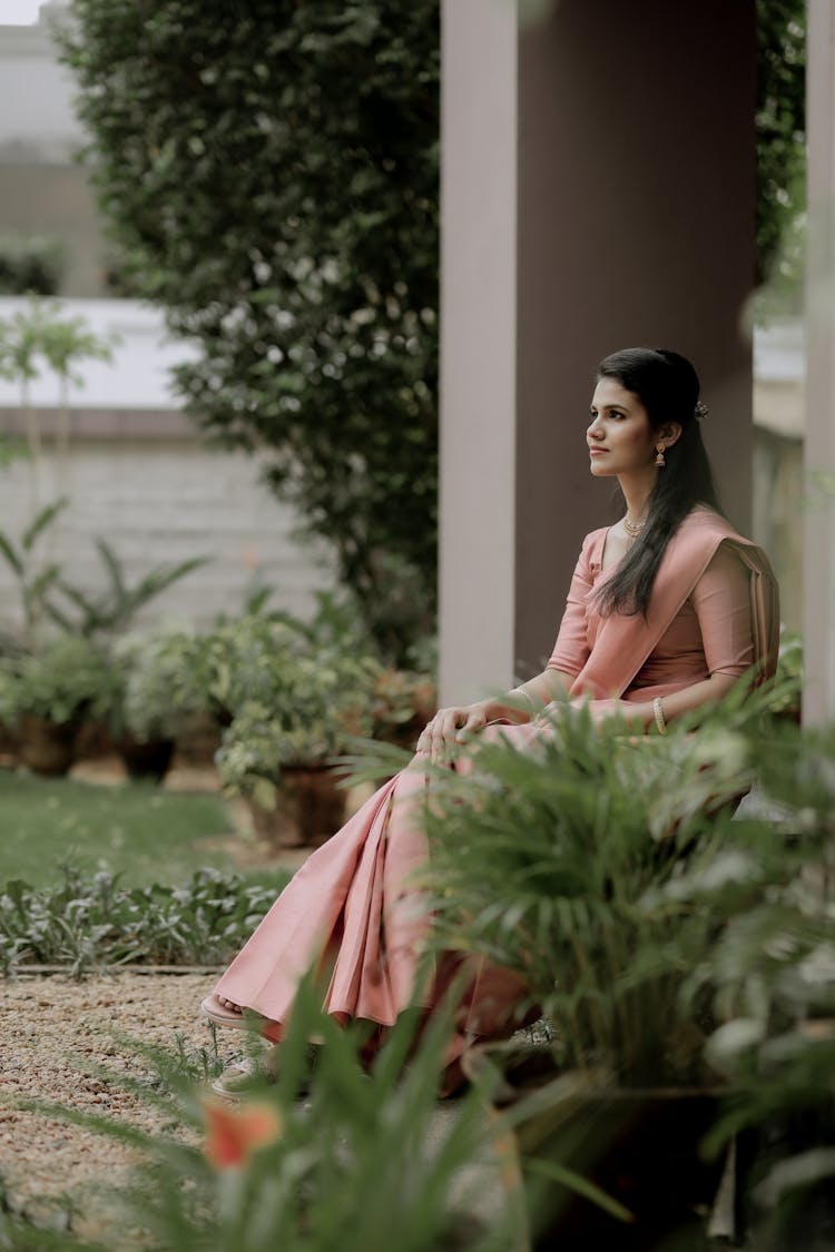 Young Elegant Woman Sitting Outside