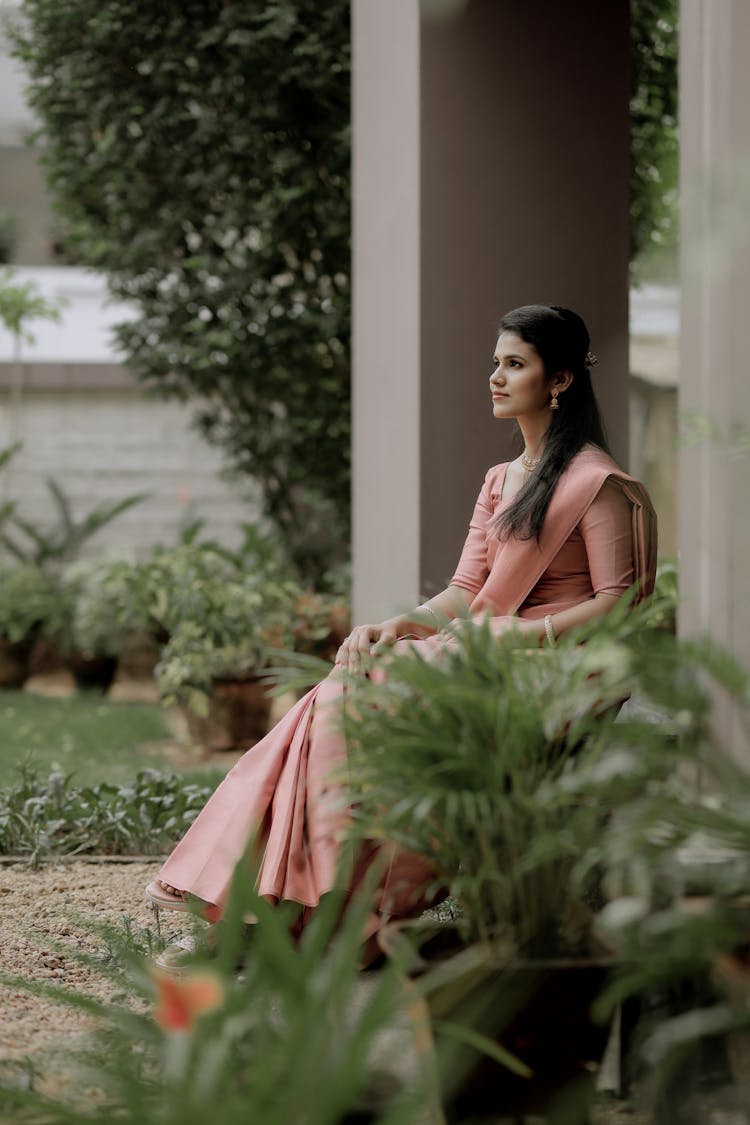 Young Elegant Woman Sitting Outside