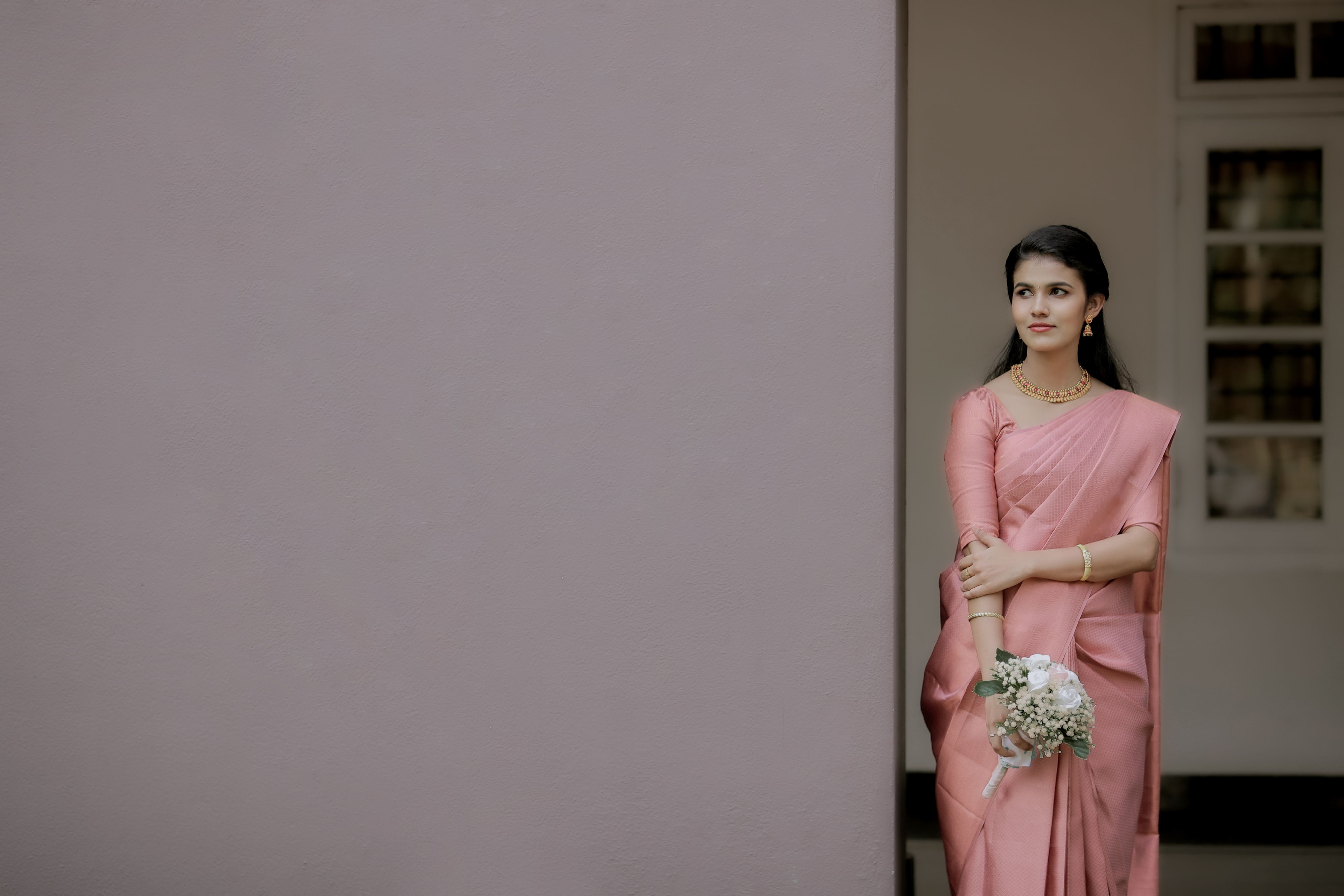 A Woman in a Pink Sari Holding a Bouquet · Free Stock Photo