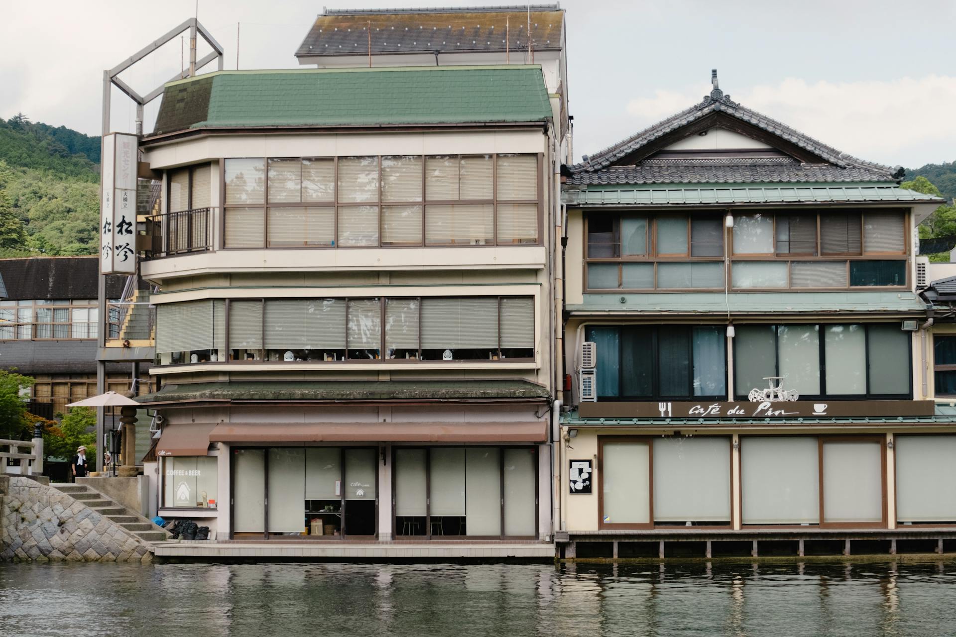 Scenic view of traditional buildings along a canal in Miyazu, Kyoto. Discover Japanese cultural charm.