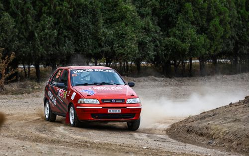 Free A Fiat Palio rally car speeding on a dirt road during an outdoor racing event. Stock Photo