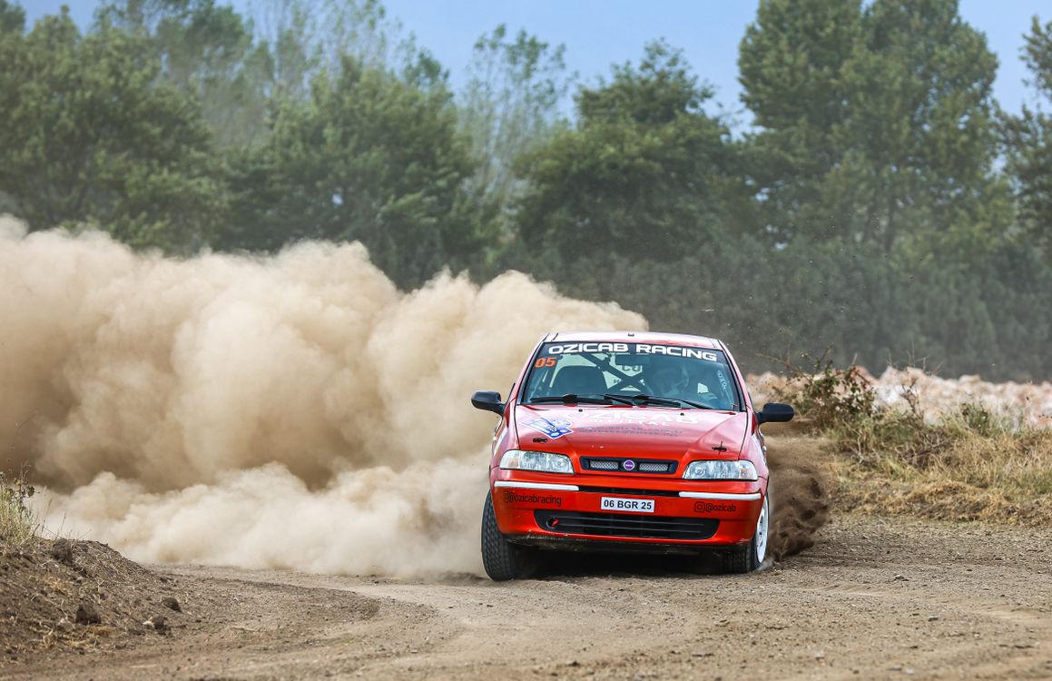 A red car driving on a dirt road · Free Stock Photo