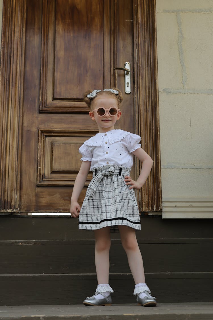 Cute Little Girl In White Blouse And Skirt