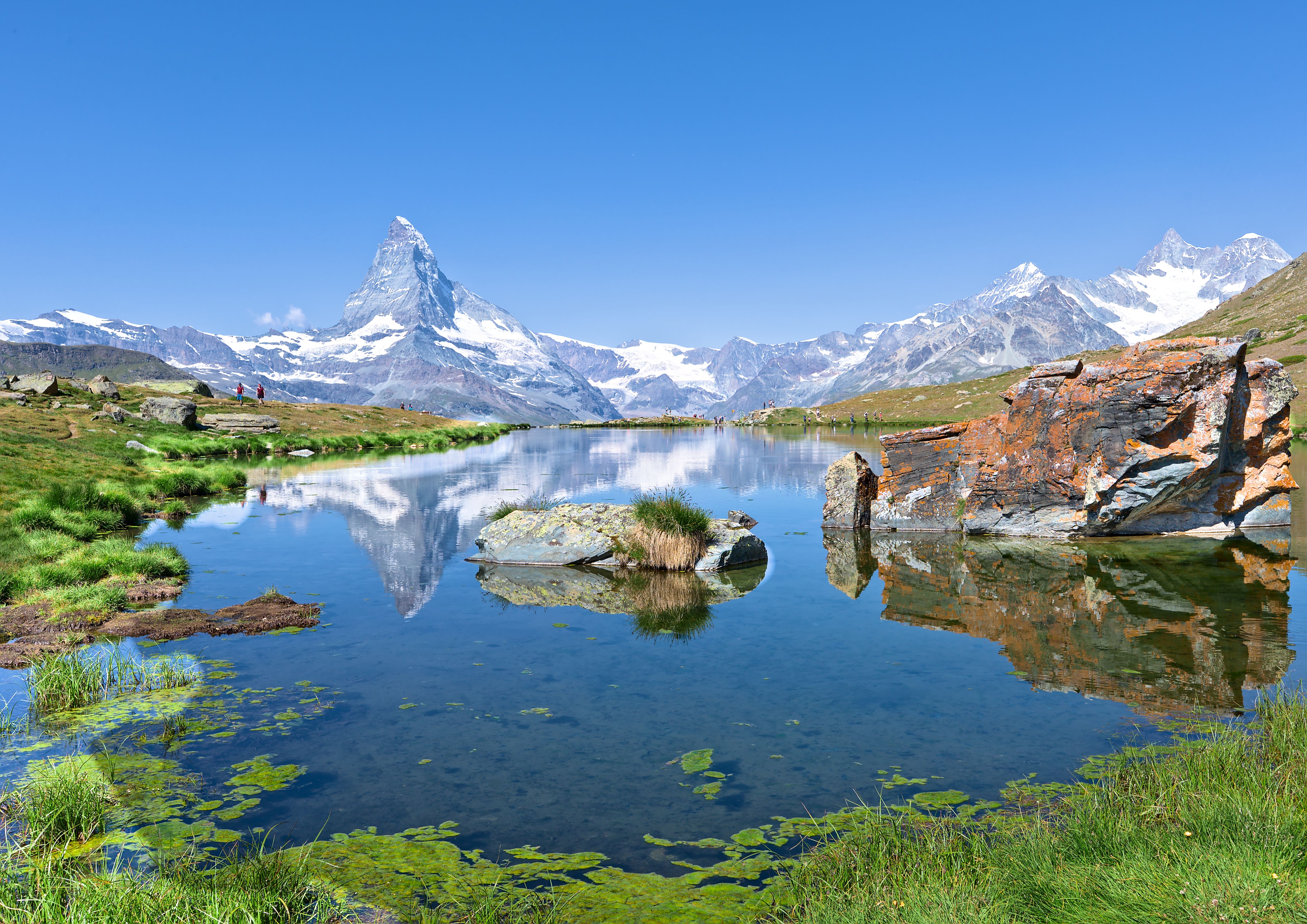 Pristine mountain lake reflecting surrounding peaks