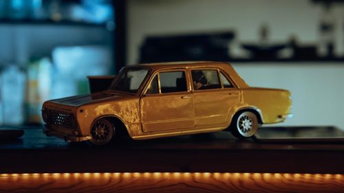 Free Vintage toy car model on a shelf with moody lighting, capturing a classic vibe. Stock Photo