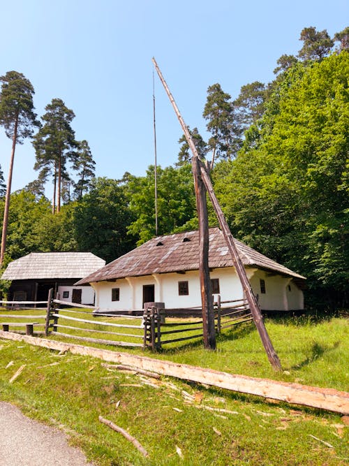 A wooden house with a pole in front of it