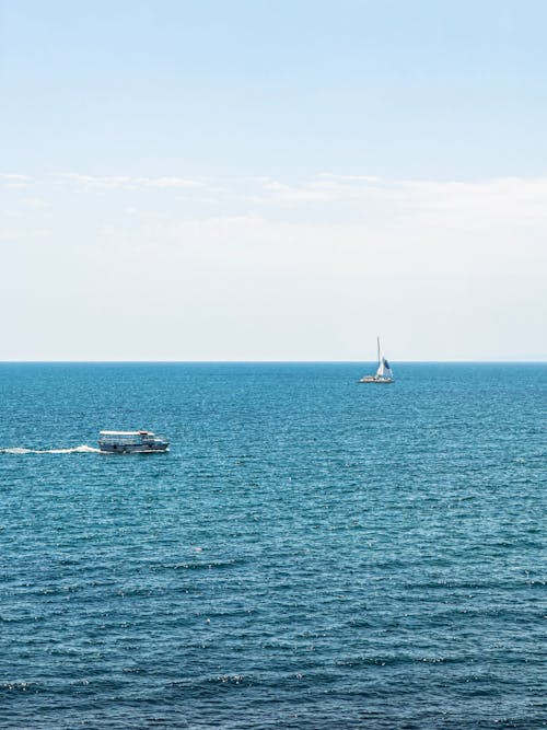 Motorboat and Sailboat on Calm Sea