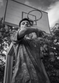 Black and white portrait of a man playing basketball outdoors in Peru.