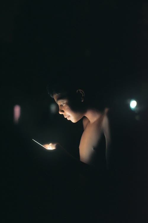 Boy Looking at his Phone Screen 