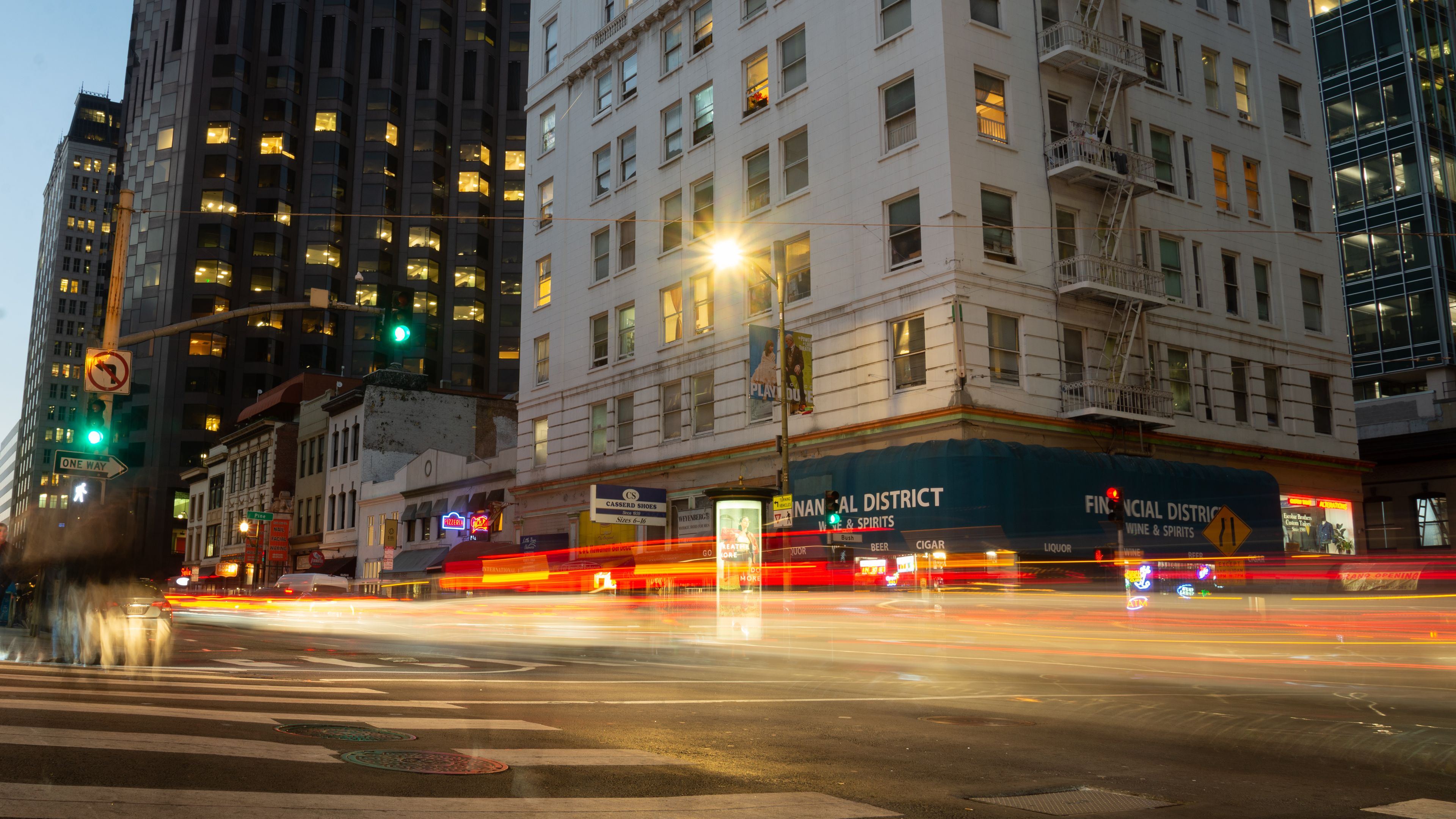 Blurred city lights and traffic in a downtown urban area at night.