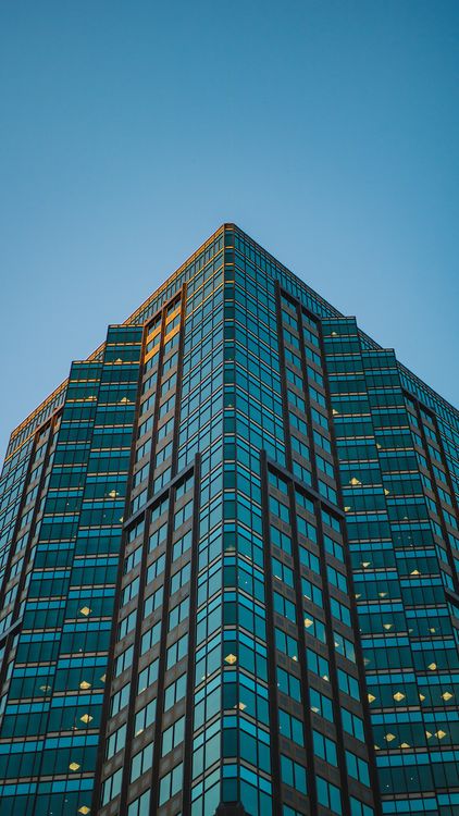 A tall building with windows and a blue sky · Free Stock Photo