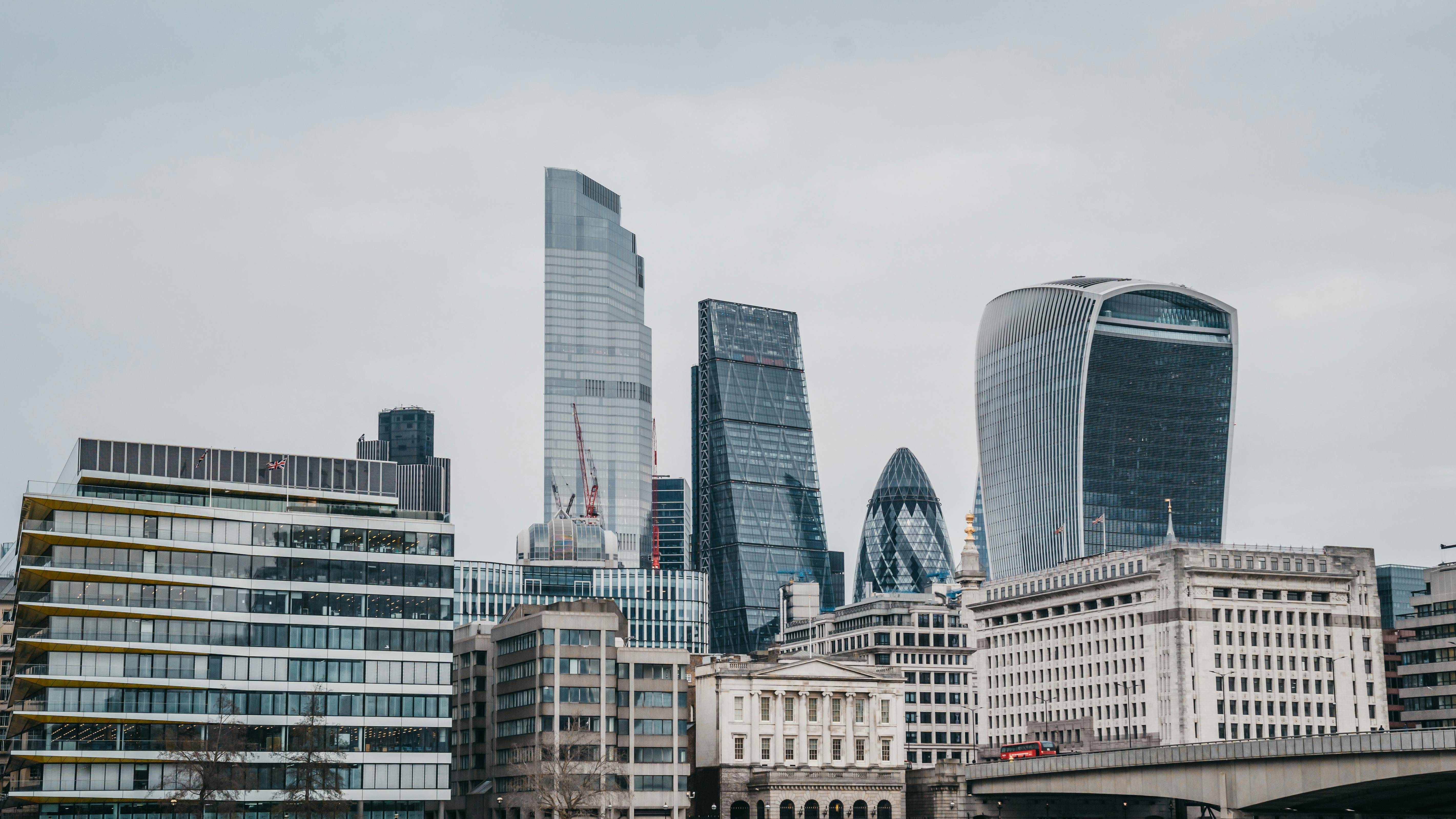 Panoramic view of London's modern skyline featuring iconic skyscrapers on an overcast day.