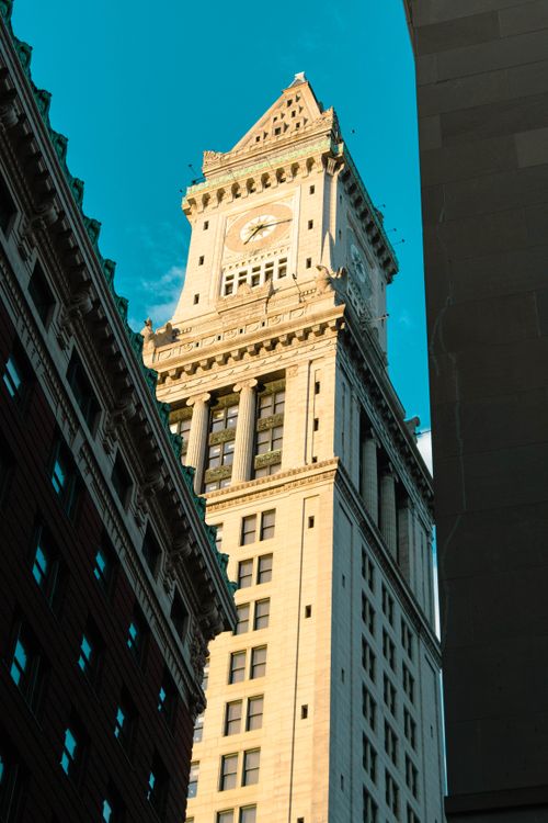Free Stunning view of Boston's Custom House Tower against a clear blue sky, illuminated by sunlight. Stock Photo