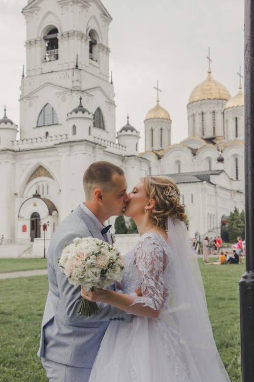 Bride and Groom Kissing in front of the Church 