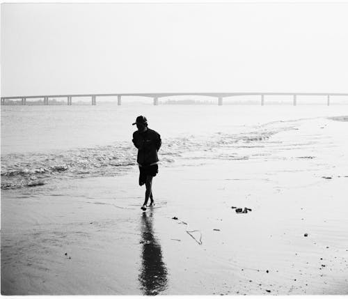 An Elderly Man Walking on the Beach 