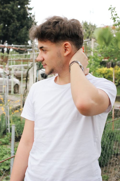 A Young Man Standing in a Park 