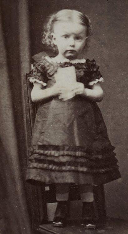 Black and White Photo of a Girl Wearing a Dress 